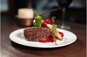 side image of steak with some vegetables