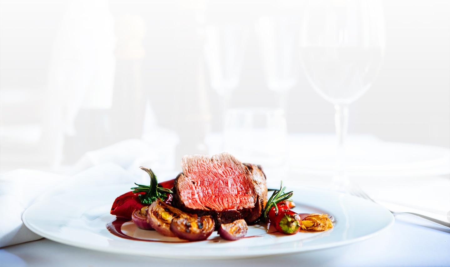 Delicious Medium Rare Beef Dish Featured in a Bright, Elegant Fine Dining Restaurant