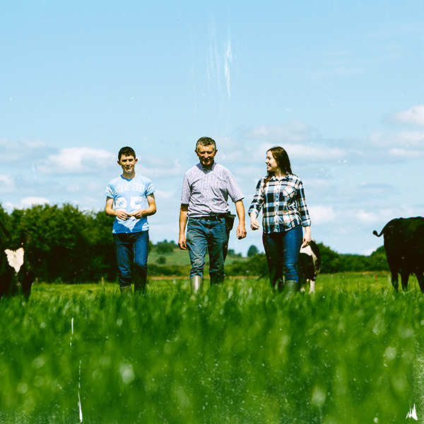Farmer and his family walking through a field