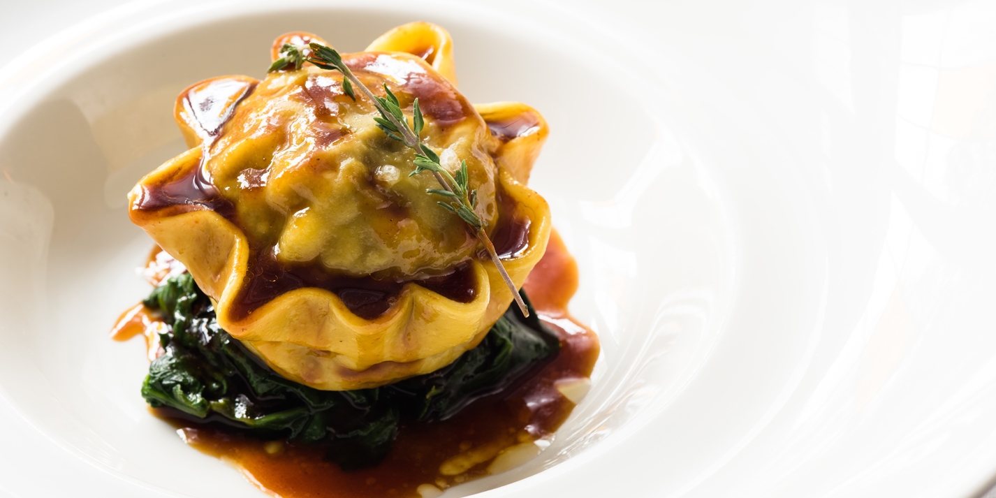 Braised Oxtail Raviolo with Celeriac, Sautéed Spinach and Oxtail Jus