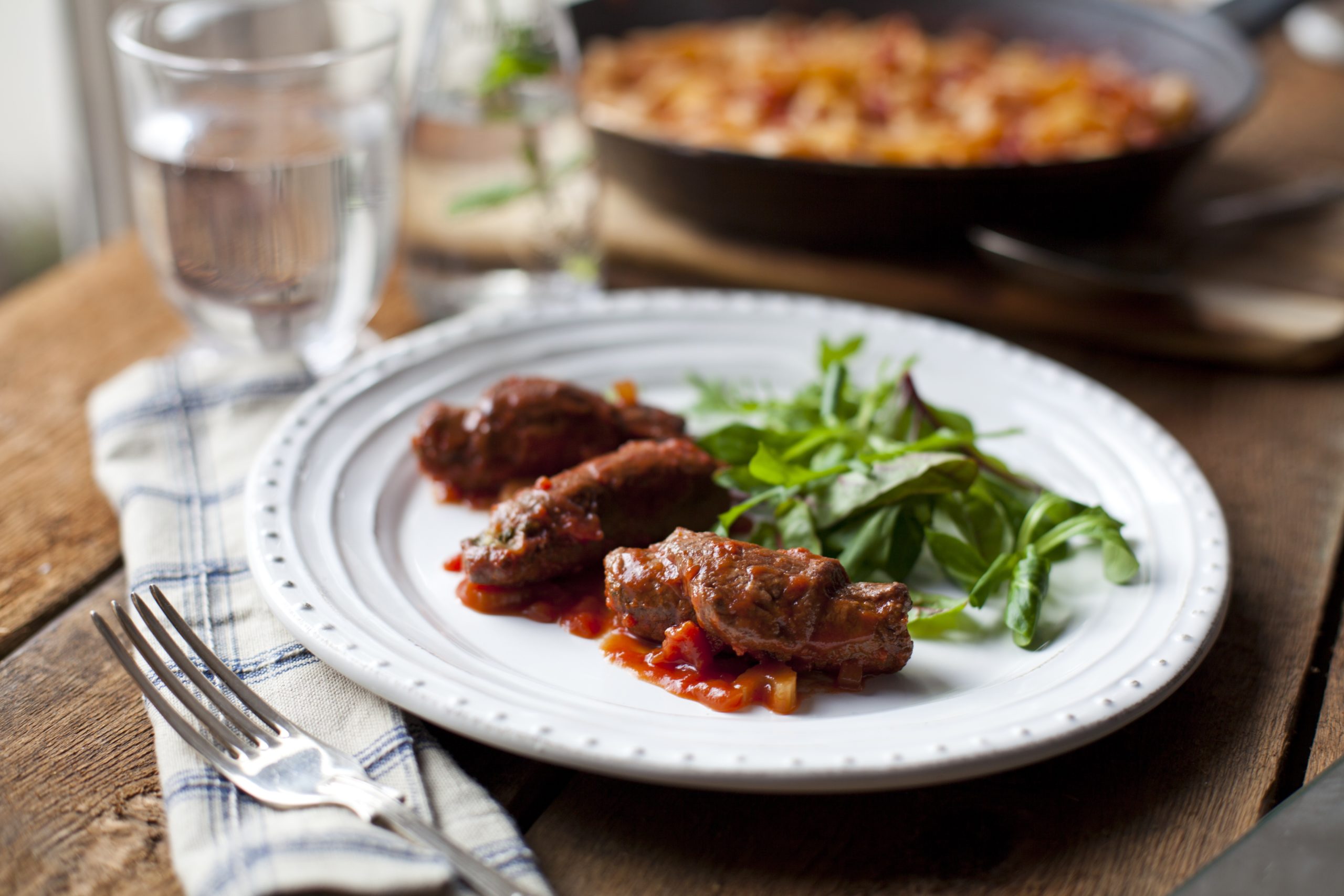 Bacon and thyme stuffed beef rolls with red wine sauce