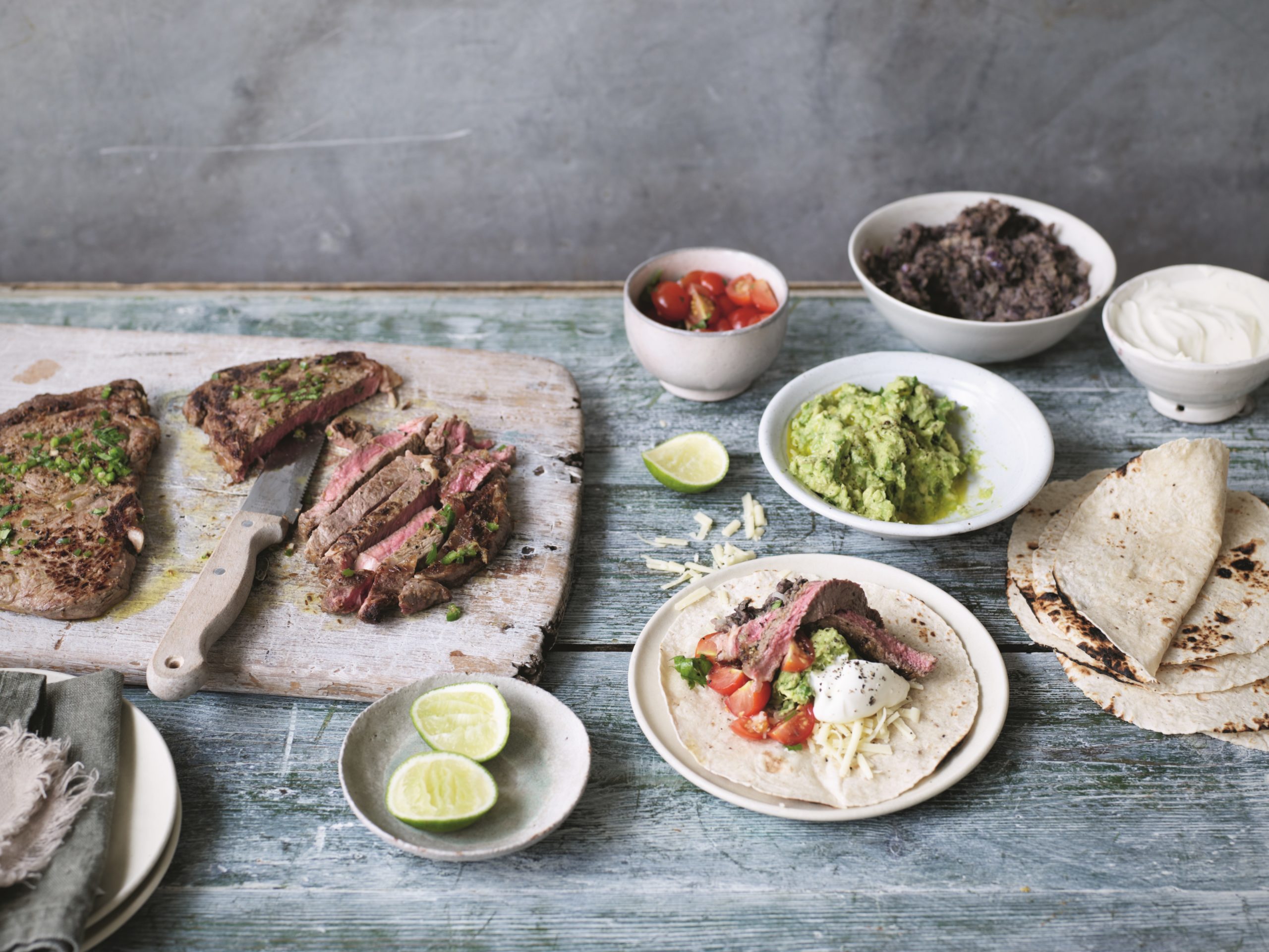 Sizzling steak fajitas with homemade salsa and guacamole