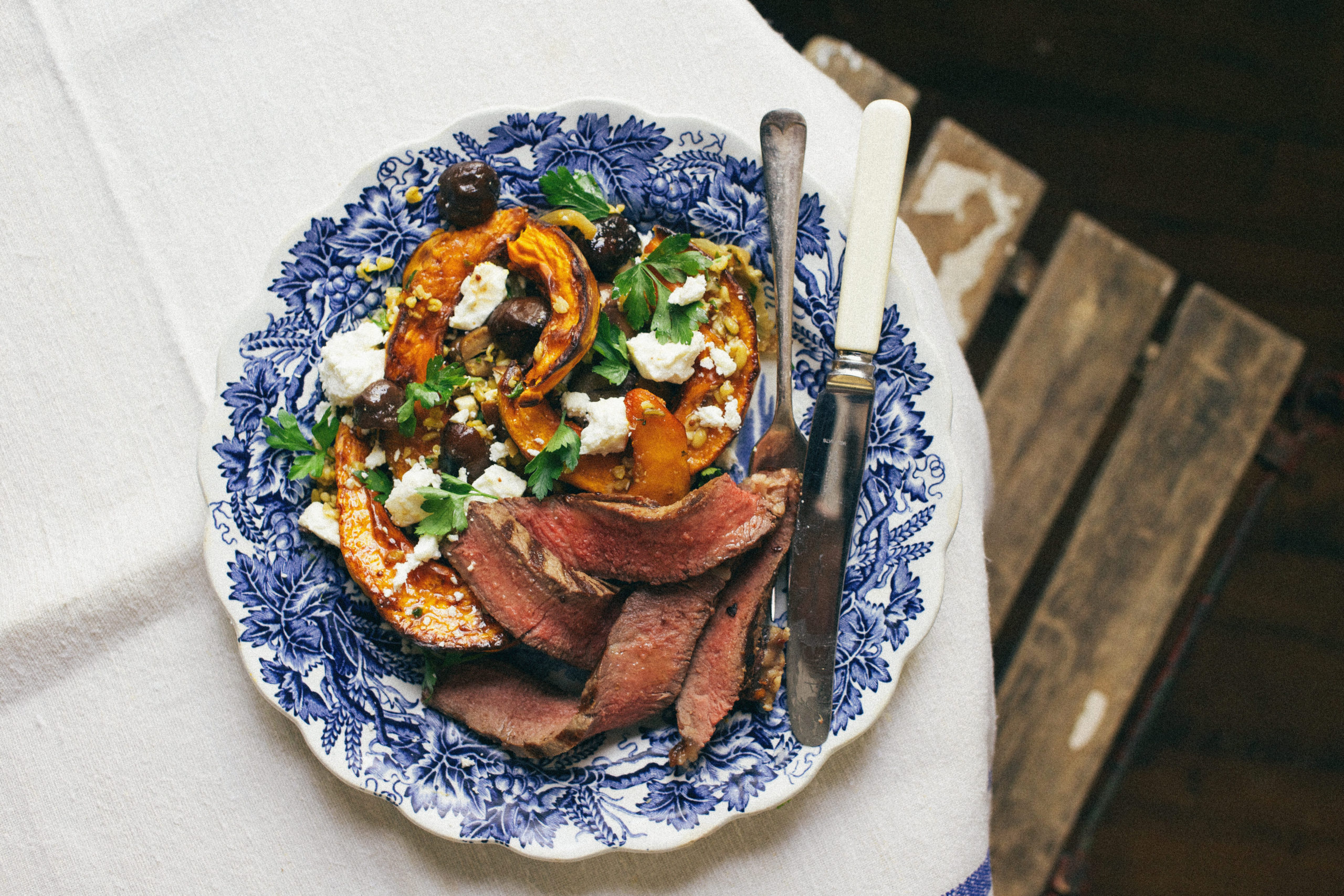 T-bone steak with roasted pumpkin, chestnuts, freekeh, feta and parsley