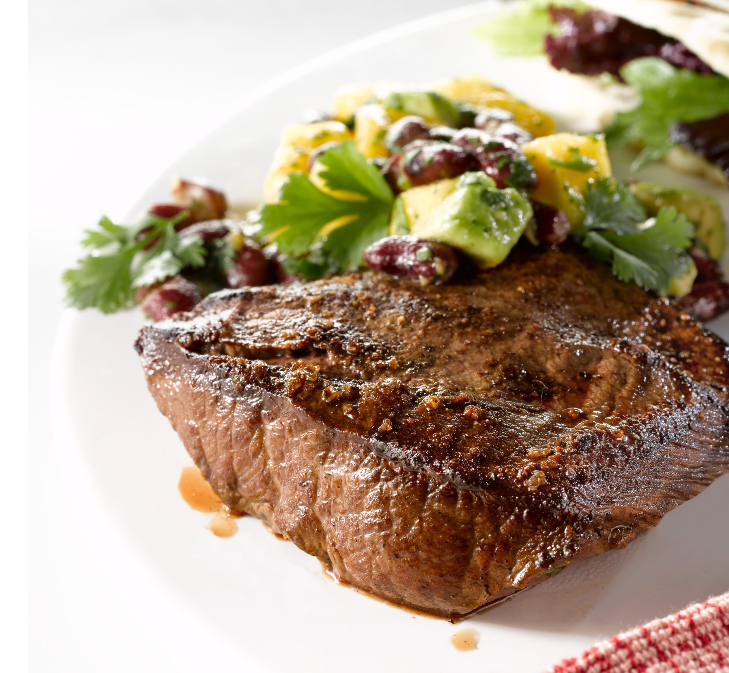 Grilled steak with kidney beans and avocado salsa