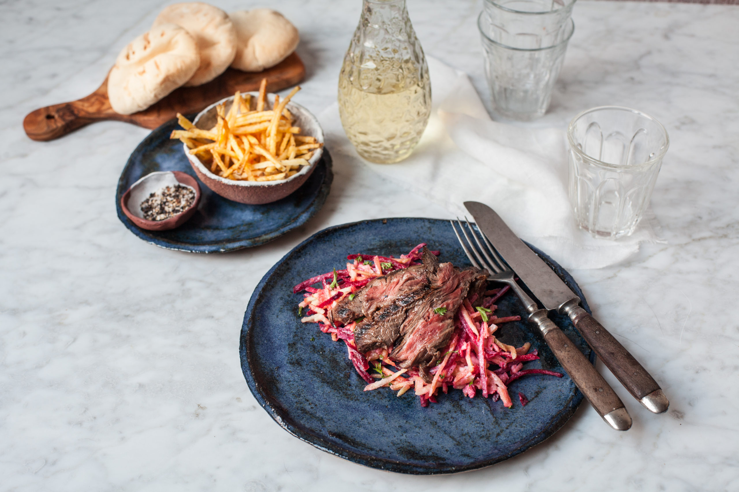 Marinated Irish skirt steak on a fresh roots salad and crispy matchstick fries