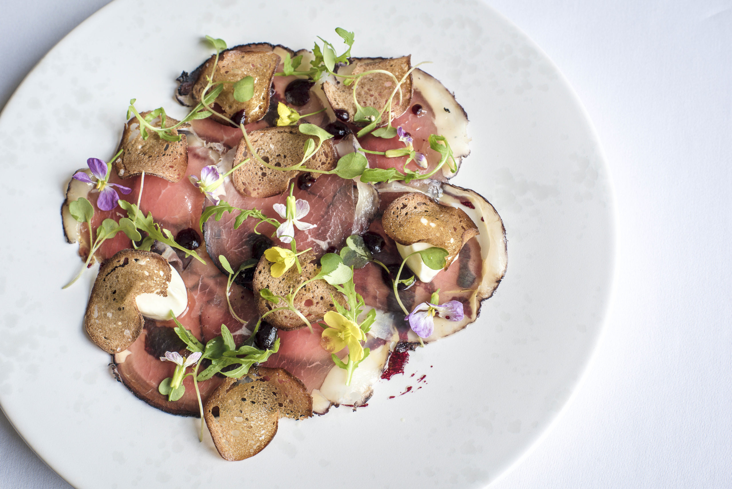 Bresaola of Irish silverside with blackcurrants, ricotta and rocket