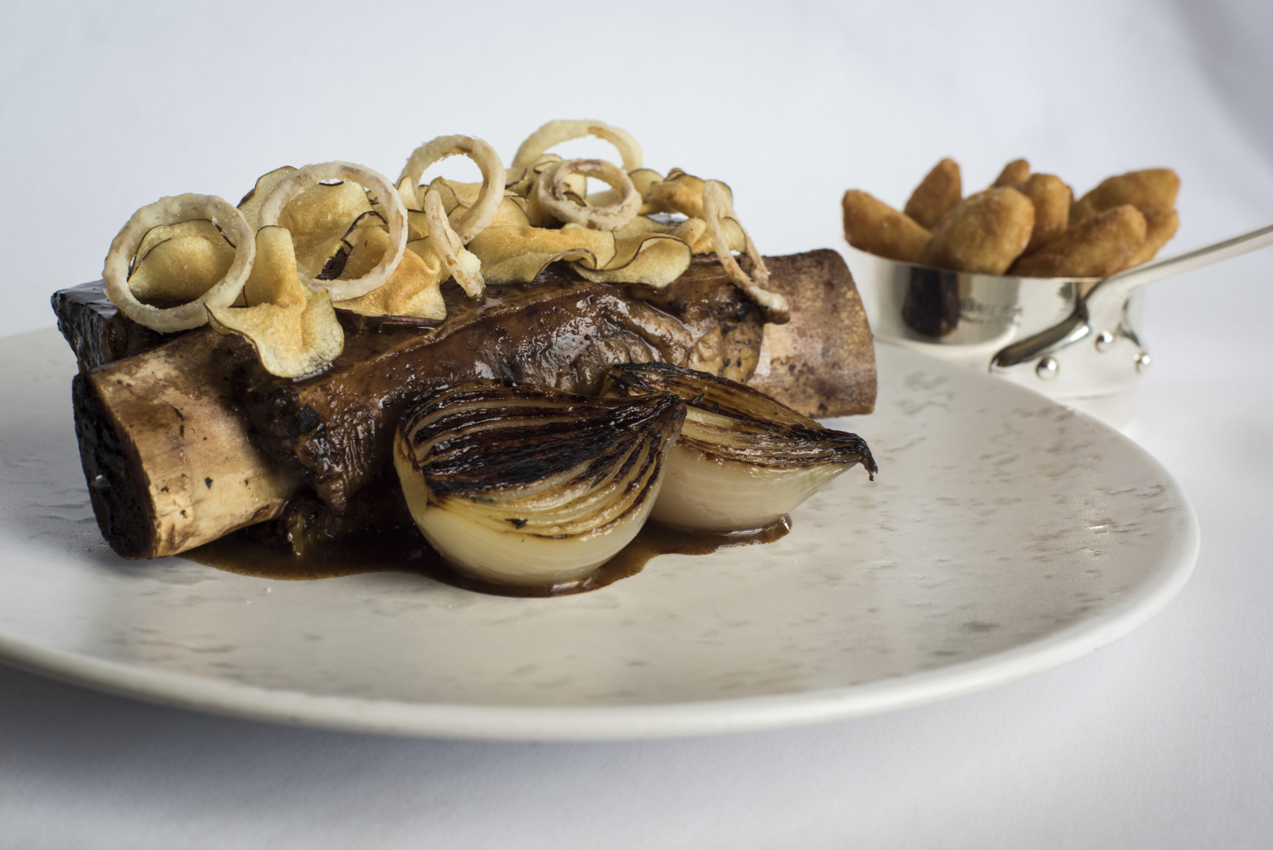 Slow-cooked Jacob’s ladder, Jerusalem artichoke chips, Roscoff onions