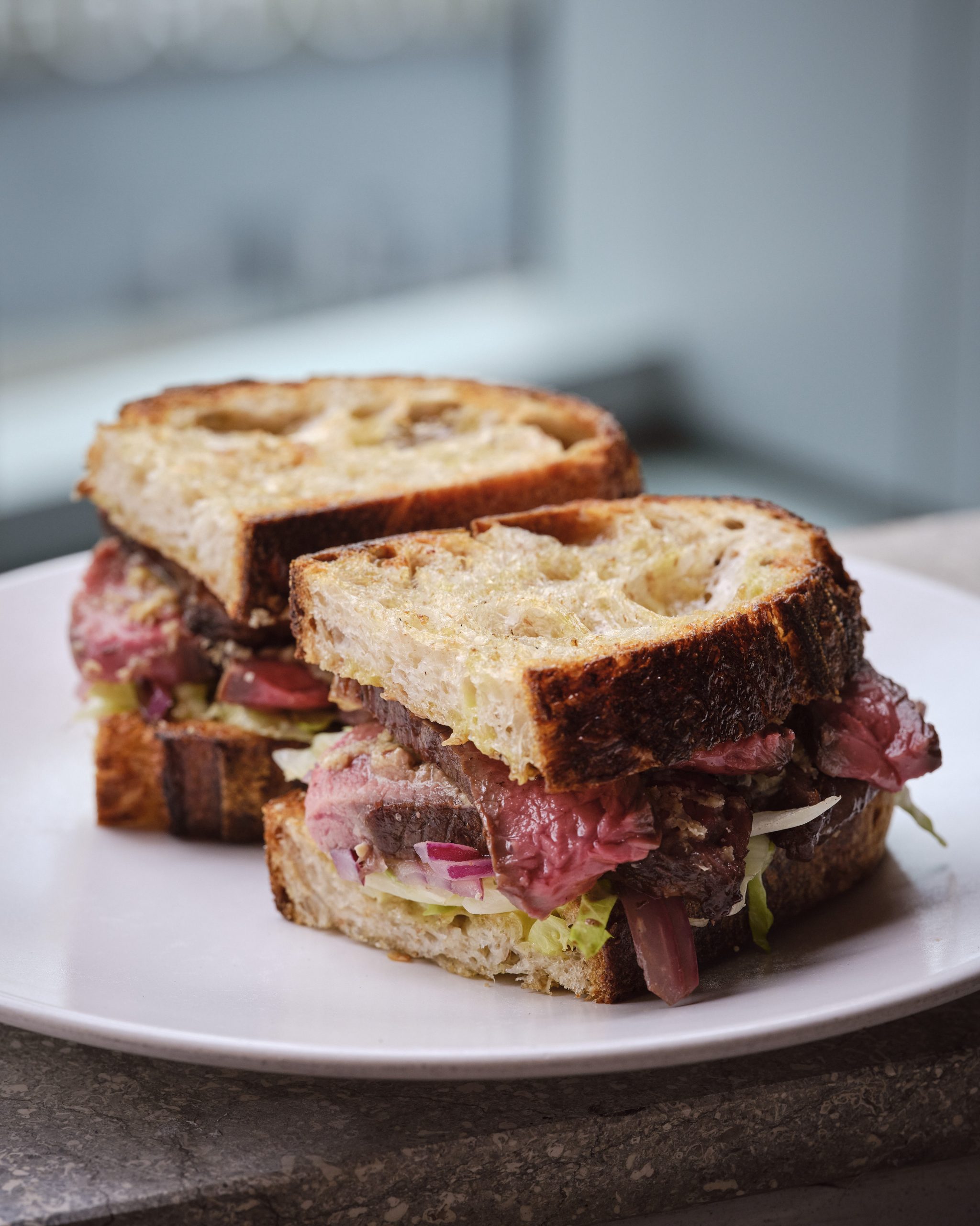 Barbequed topside steak sandwich, pickled onion, blue cheese & aioli